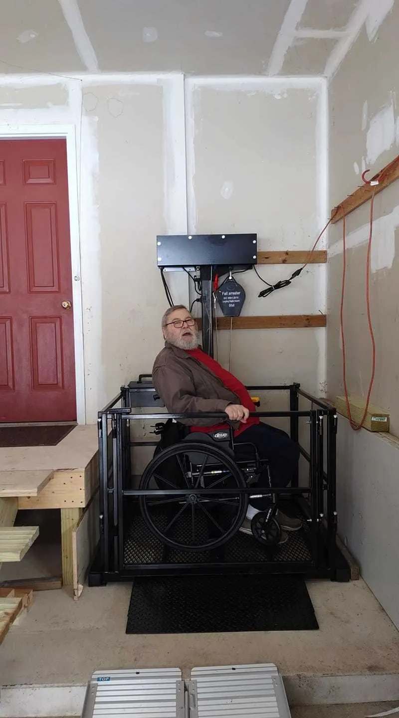 Garage platform lift with wheelchair user