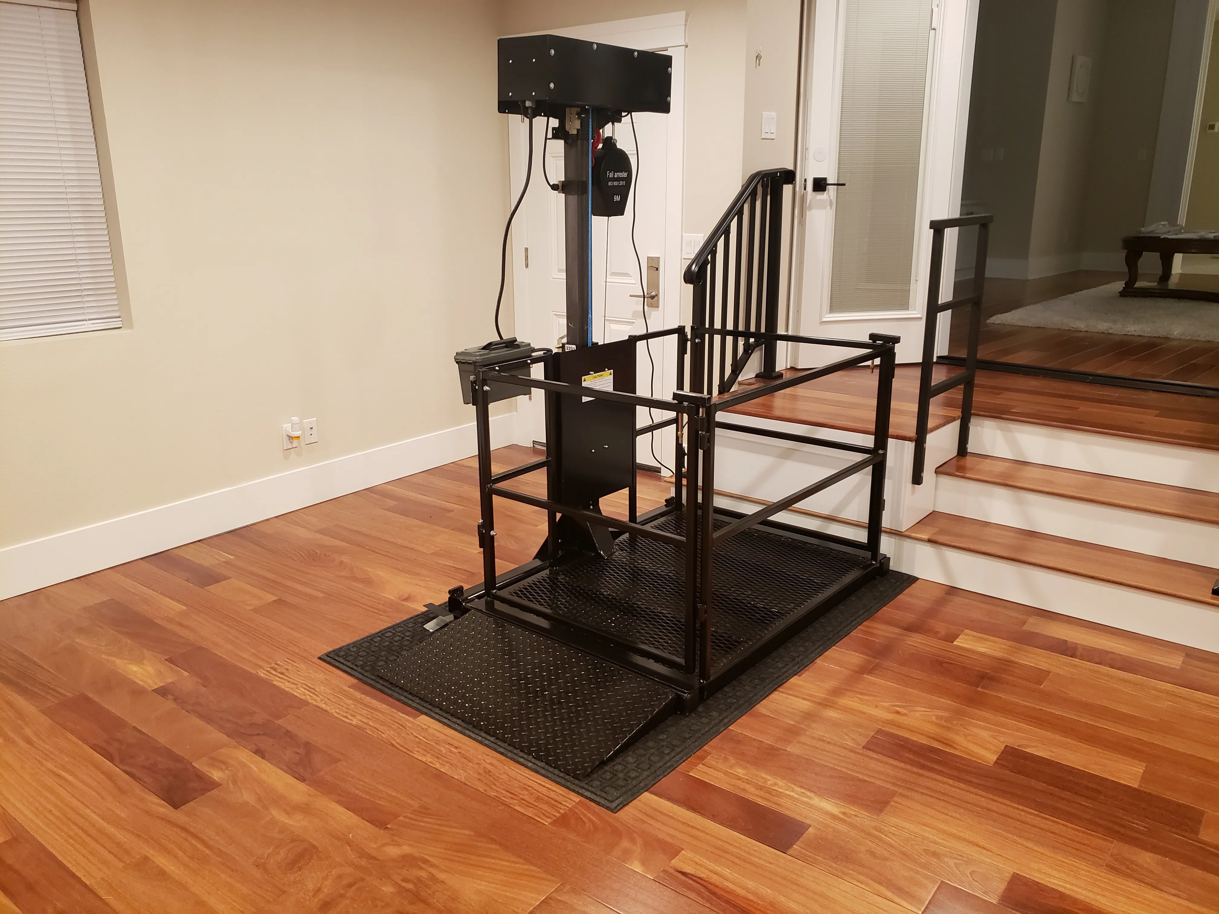 Vertical platform lift at a garage entrance